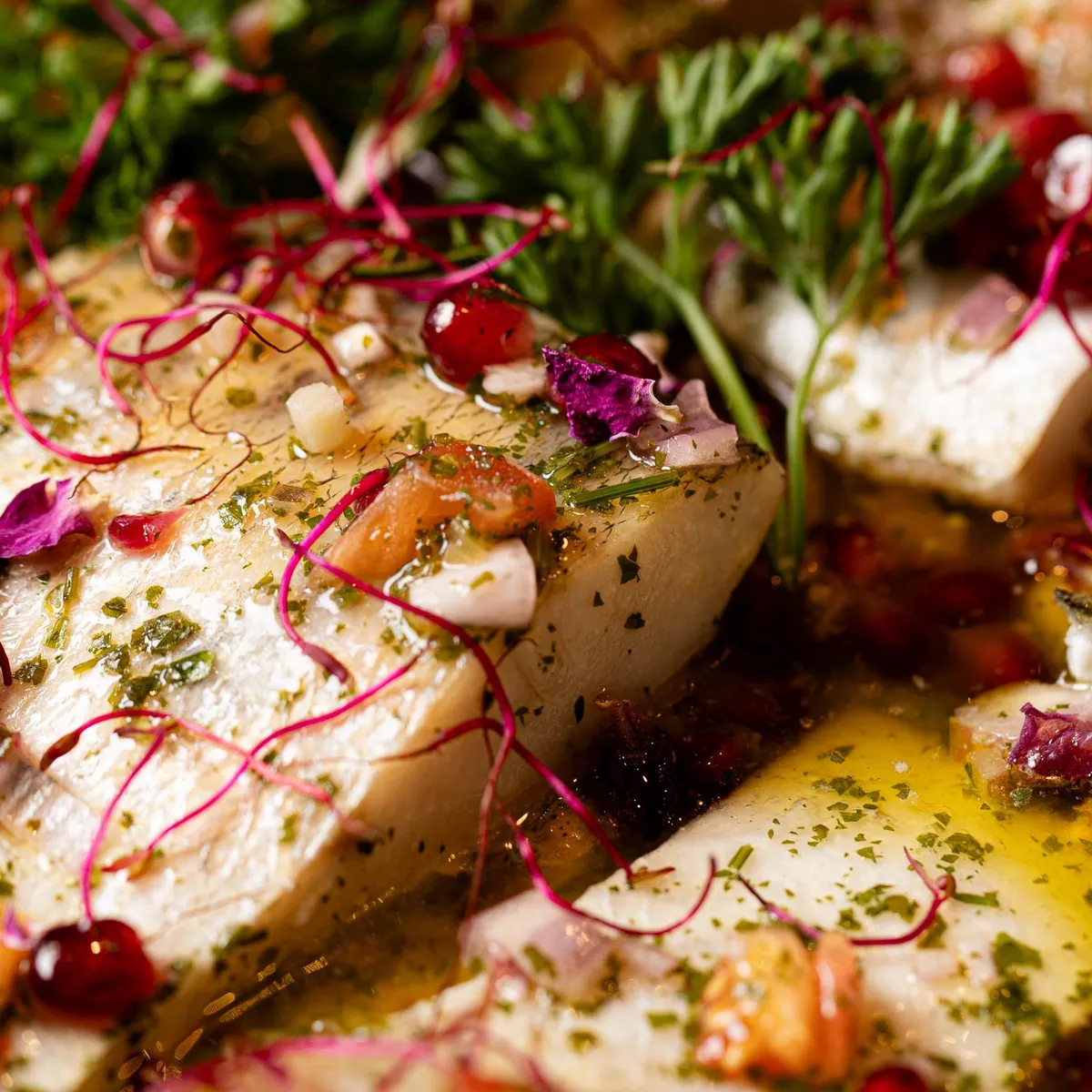 Pizza topped with radishes, cheese, olives, and fresh herbs