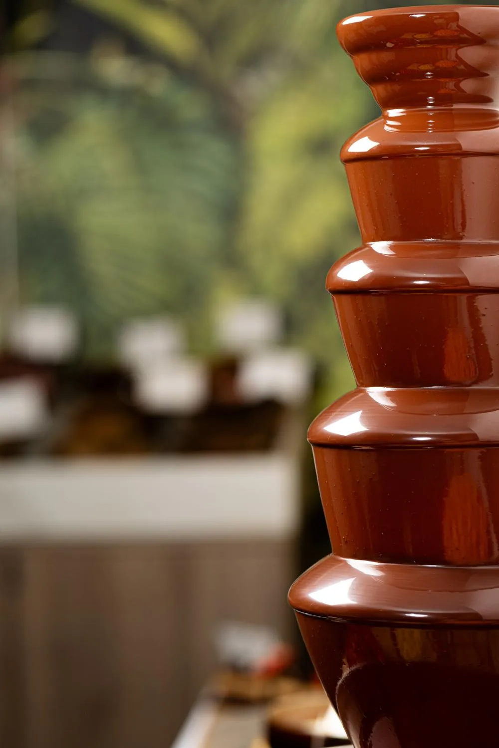 A series of clay pots stacked in front of a blurred background of vegetation and stone structures